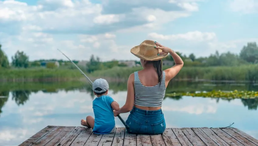Woman Fishing With Son